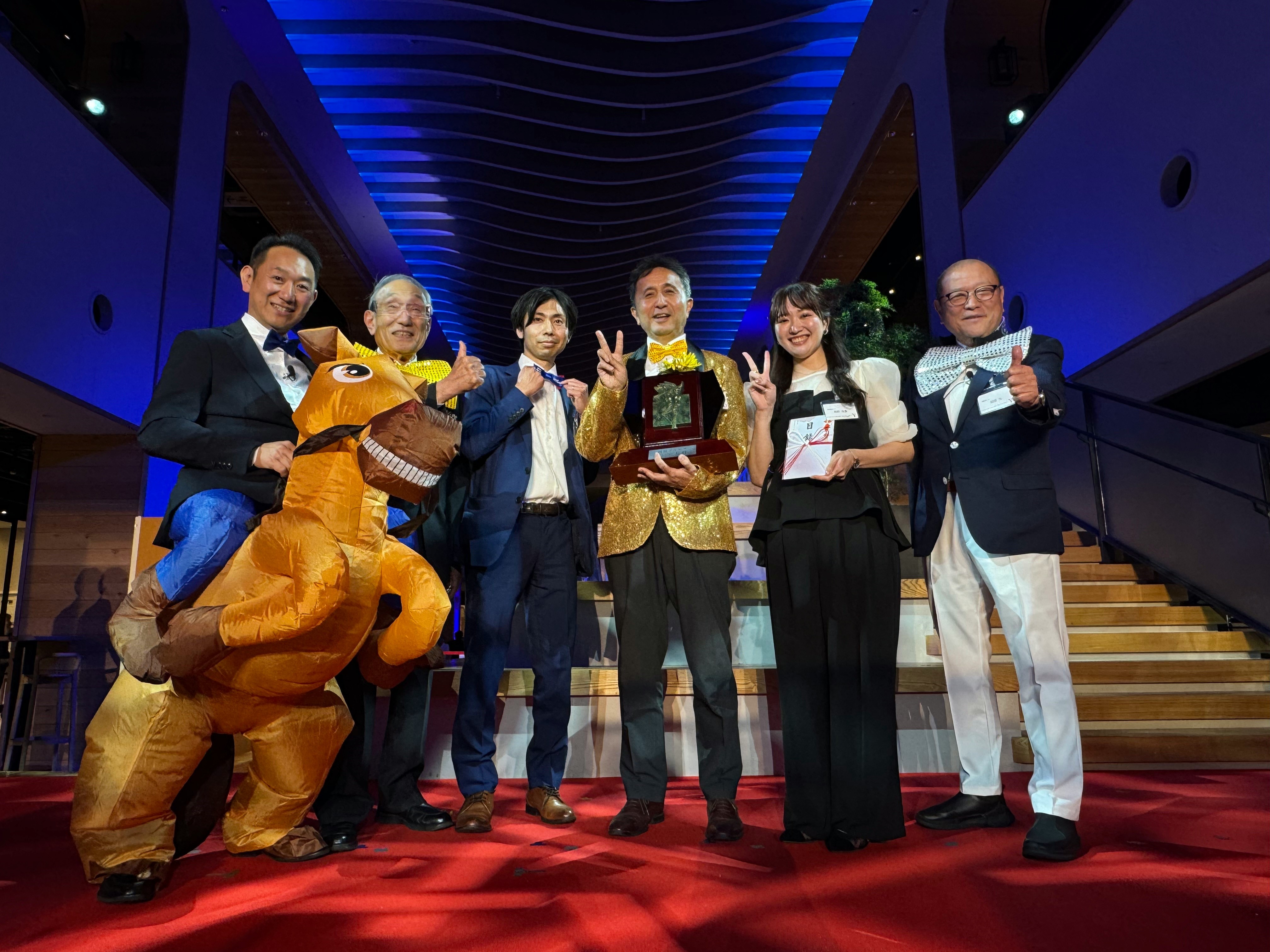 （写真左から）松田グループプレジデント、小嶋会長、鈴木さん（シンク）、丸山社長、青野さん（シンク）、松田ヴァイスチェアマン